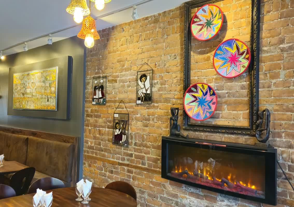 restaurant's picture showing wall with arts and a cheminey